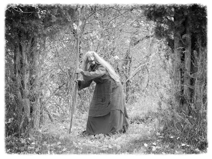 A lone witch in the woods hearing voices only they can hear.